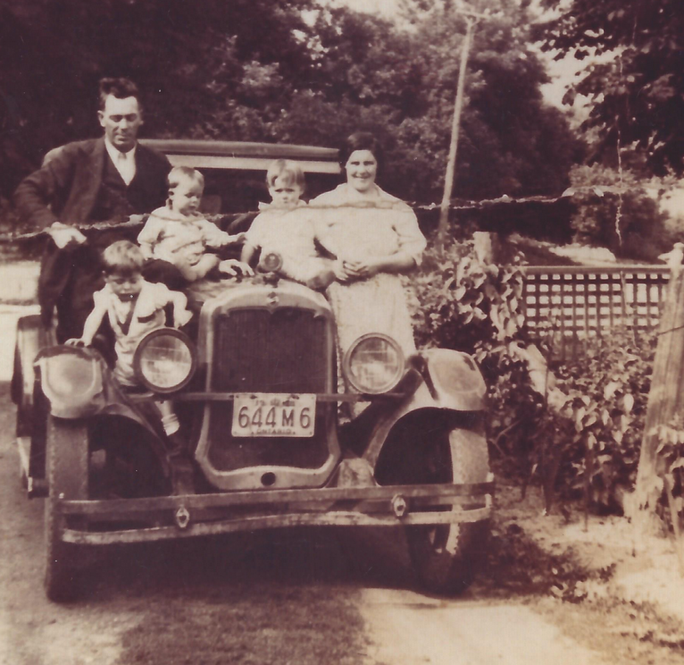 Albert Hill and wife Margaret Porter along with their three oldest children - Arnold, George and Jessie on the hood of their car in the early 1940s. 
